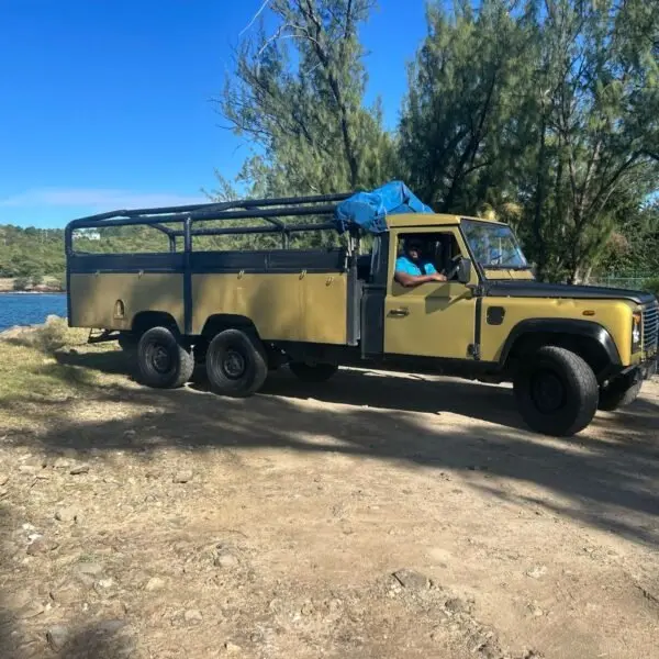 C&M safari vehicle parked near the coast